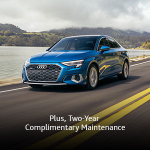 Side view of an Audi Q3 driving.